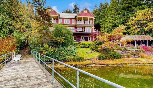 Luxury waterfront home with hot tub, dock, game room, and stunning views